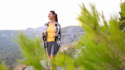 Female hiker pausing to take in the beautiful mountain scenery