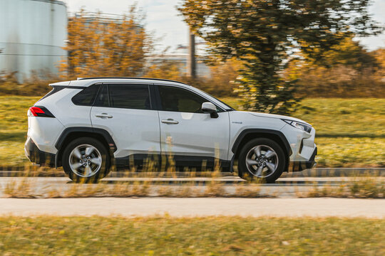 Toyota rav4 Hybrid. A white car is driving on an asphalted street. Riga, Latvia - 22 Sep 2024