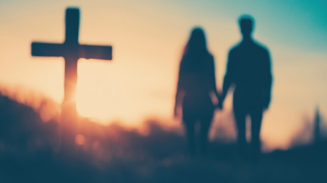 A couple strolls together, holding hands, as they approach a cross silhouetted against a vibrant sunset sky - Powered by Adobe