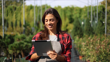 Fototapeta premium Beautiful owner of a gardening center managing work 