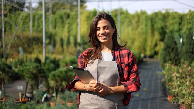 Portrait of a female engineer from the gardening center overseeing gardening process