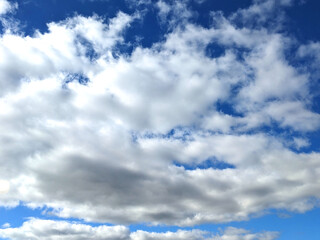 Fototapeta premium Fluffy White Clouds in a Blue Sky as A Skyscape Background