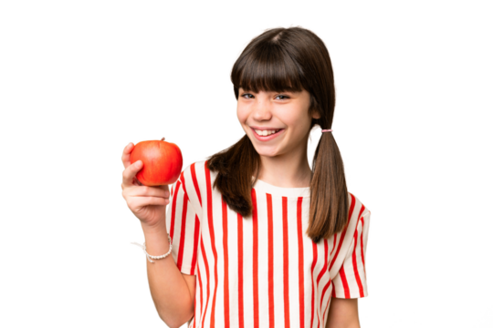 Little caucasian girl holding an apple over isolated background smiling a lot