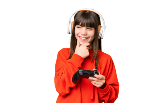 Little caucasian girl playing with a video game controller over isolated background looking to the side and smiling