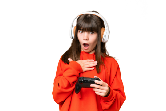 Little caucasian girl playing with a video game controller over isolated background surprised and shocked while looking right
