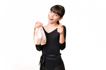 Little caucasian girl practicing ballet over isolated background pointing front with happy expression