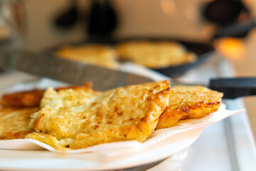 Golden-browned zucchini patties elegantly arranged on a plate, showcasing a crispy texture and vibrant color. A wholesome, vegetarian delight perfect for any meal