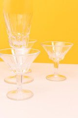 Crystal glasses in front of yellow background.