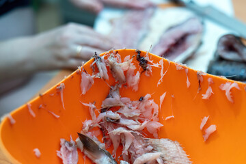 striking juxtaposition of salmon bones and entrails rests at the rim of a bowl, highlighting the...