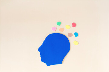 The silhouette of a human head and thoughts are messages in the form of colored messages around the head. A person receives information from different sources