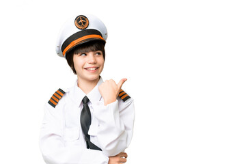 Little girl as a Airplane pilot over isolated chroma key background pointing to the side to present a product