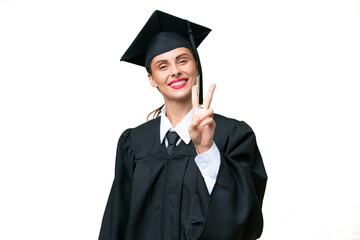 Young university graduate  caucasian woman over isolated background smiling and showing victory sign