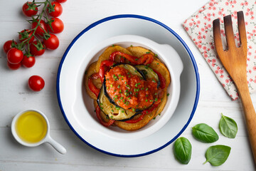 Mallorquin Tumbet. Roasted vegetables with tomato sauce. Top view table with  decoration.