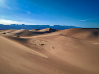 Golden and smooth sand dunes. Mesquite Flat Sand Dunes, Death Valley National Park, California, USA. Desert sand pattern