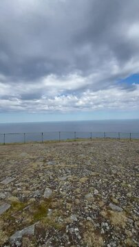 North Cape, Mager&oslash;ya, Nordkapp Municipality, Finnmark, Norway - panorama view away from the main attractions sightseeing location on cloudy day with few tourists