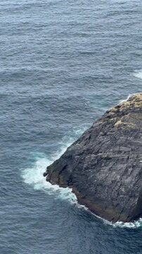North Cape, Mager&oslash;ya, Nordkapp Municipality, Finnmark, Norway - Cliffs view away from the main attractions sightseeing location on cloudy day with few tourists