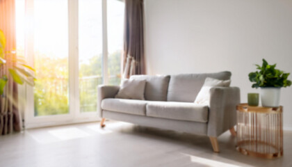 Blur living room at home with morning sunlight at big window for background usage. blur interior background concept.