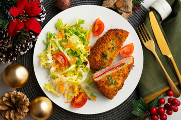 Asturian Cachopo. Breaded beef fillet stuffed with cheese and pepper. Top view table with Christmas decoration.