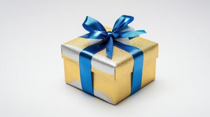 Obraz premium Festive gold and silver New Year gift with a blue ribbon, isolated on a white background for a simple, elegant touch.