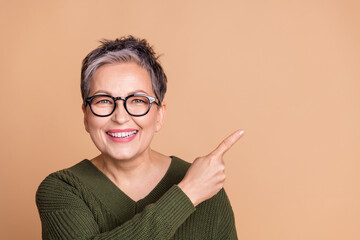 Photo of cheerful woman with short hairdo dressed sweater in glasses directing at sale empty space...