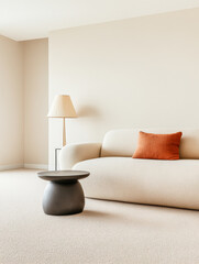 Cozy living room with neutral tones featuring a modern sofa, decorative pillow, and simple lamp in a bright interior setting