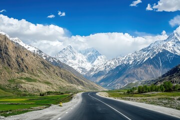 Fototapeta premium Scenic mountain road through snowy peaks