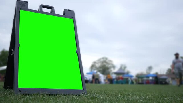 A Green Screen Foldout Sign at a Carnival or Fair