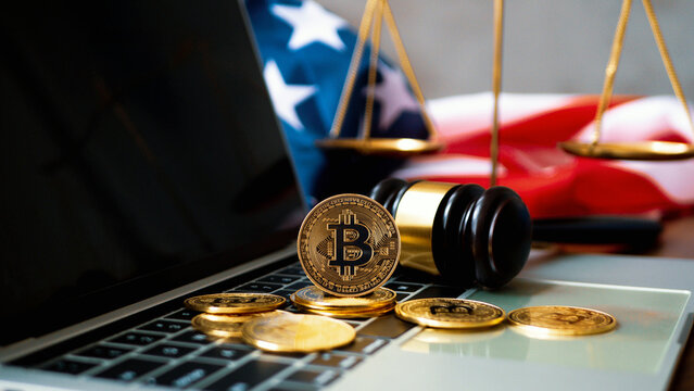 Cryptocurrency Law Bitcoin ban violation of law Cryptocurrency. gavel and bitcoins with the United States of America flag on the table.Cryptocurrency Legislation.