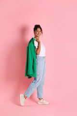 Naklejka premium Beautiful woman with stylish jacket on pink background