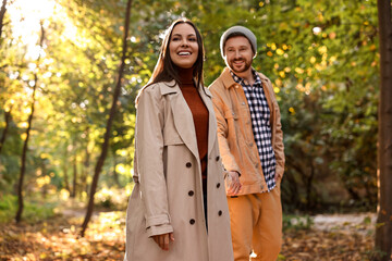 Fototapeta premium Beautiful couple walking together in autumn park, selective focus