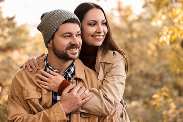 Fototapeta premium Beautiful happy couple hugging outdoors on autumn day