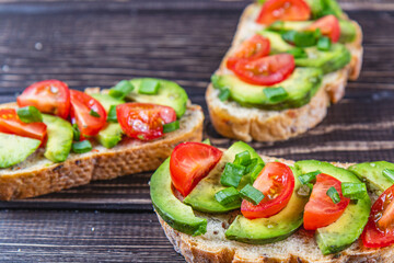 Avocado toast topped with tomato and green onion on a slice of carrot bread