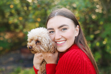 Portrait of woman with cute dog outdoors