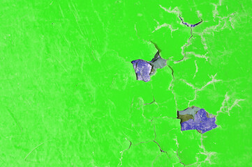 Peeling paint of green color, peeling paint texture. Texture background of bright green peeling paint on the old rough surface