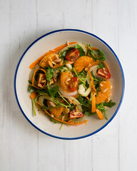 Healthy green fennel and mandarin salad. Top view table with  decorations.