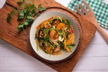 Healthy green fennel and mandarin salad. Top view table with  decorations.