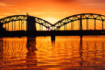 Fototapeta premium Sunset over Railroad bridge in Riga, Latvia