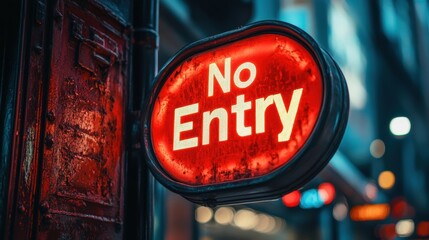 Fototapeta premium Brightly illuminated No Entry sign with a bold red background affixed to a weathered metal structure in the midst of an urban cityscape during evening hours