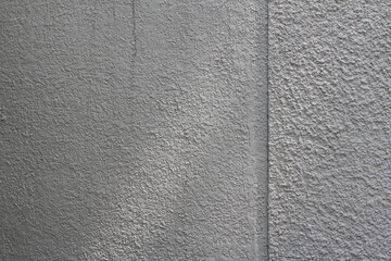 Rough surface of grey concrete wall with light and shadow background. Grey cement with stains texture.