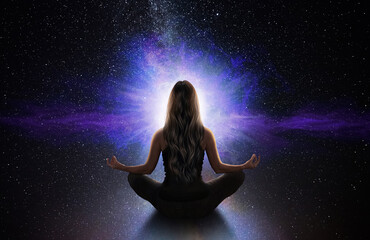 woman meditating front the universe