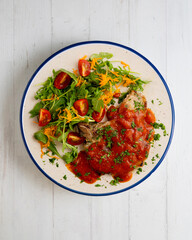 Pork chops with tomato sauce and salad. Top view table with decorations.