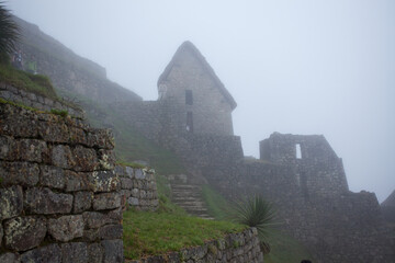 Dramatic view of the ancient ruins of Machu Picchu in the mist.