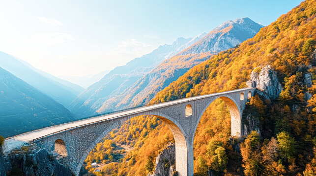 A bridge spans a valley with a mountain range in the background