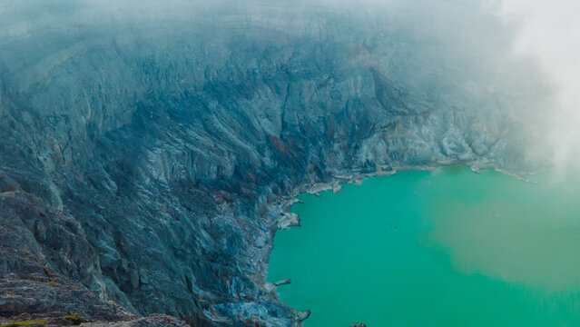 Aerial view of the beautiful scenery of the turquoise sulfur lake and volcano Kawah Ijen in East Java, Indonesia.