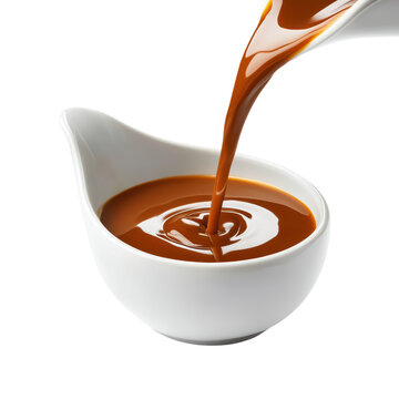Rich caramel sauce pouring into a white dish