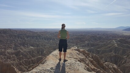 Fototapeta premium Female Hiker Looking Out at Desert from Font's Point, Anza Borrego, California