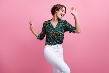 Photo of lovely adorable positive girl with bob hairstyle dressed stylish shirt dancing raising...
