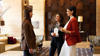 Three successful businesswomen engage in a business conversation