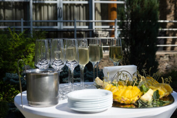 a table with wine glasses and a tray with a tray of wine glasses on it.