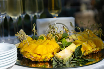 a plate of food with a slice of  pineapple on it